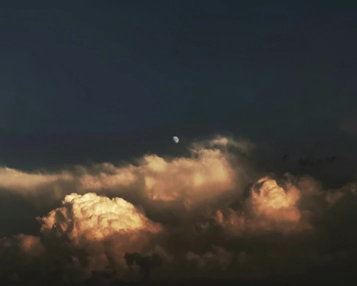 a jetliner flying through the air next to clouds