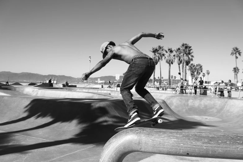 black and white pograph of young skateboarder in mid air