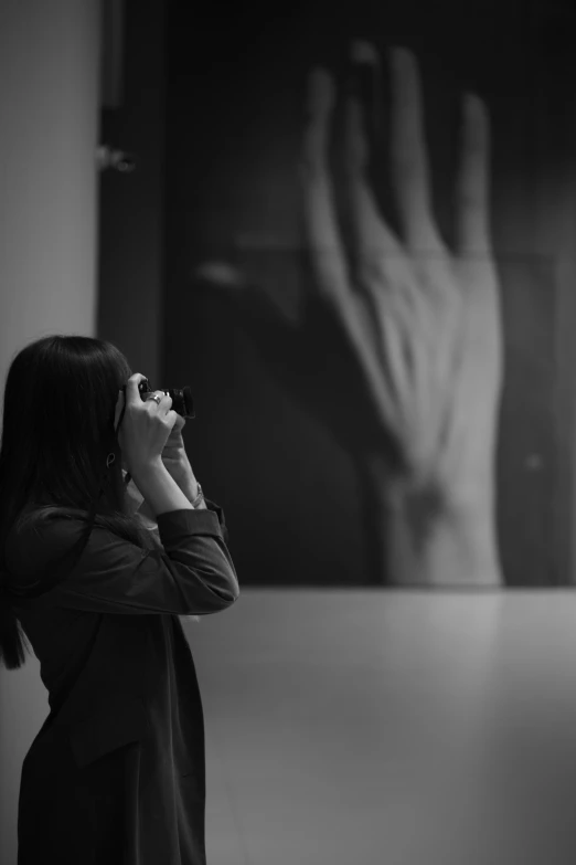 a woman in a black coat is using a phone