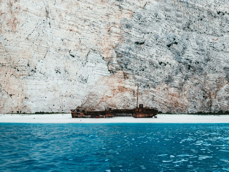 the old boat is tied to the side of the cliff