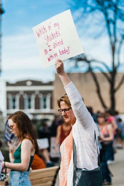 a woman holds up a sign on her head