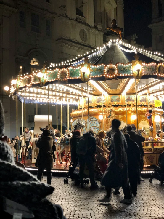 an outdoor carousel that is lit up at night