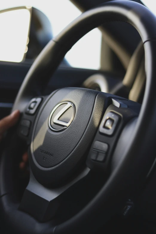 the driver is using the steering wheel in the car