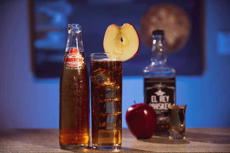 a closeup of a bottle and two glasses of liquid