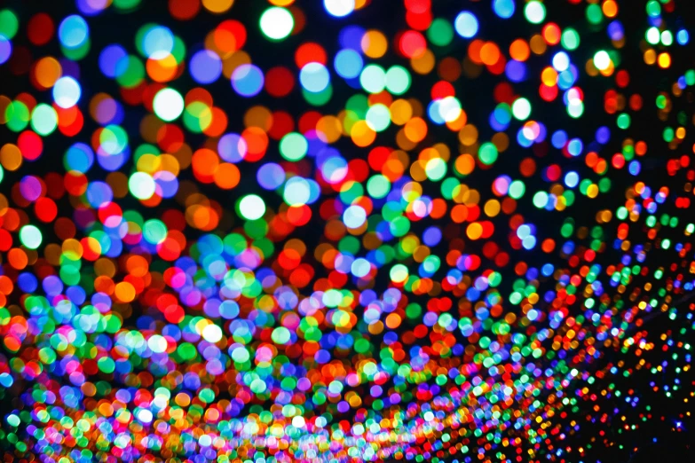 colorful lights are seen in the dark and blurred
