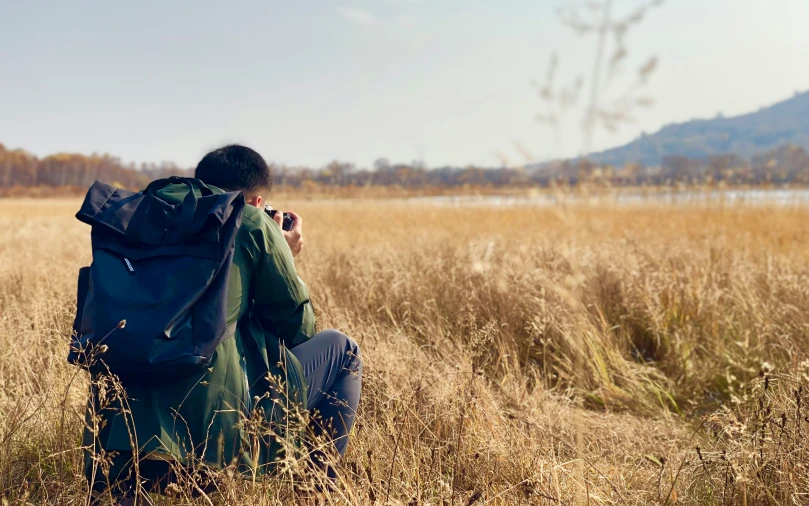 a man that is sitting in the grass