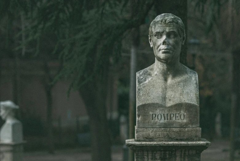 the statue is in the middle of a quiet park