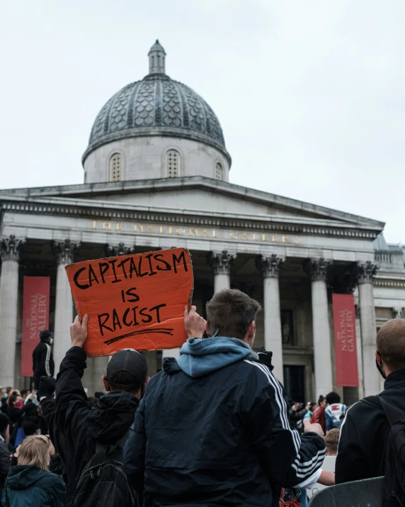 a crowd is sitting outside a large building