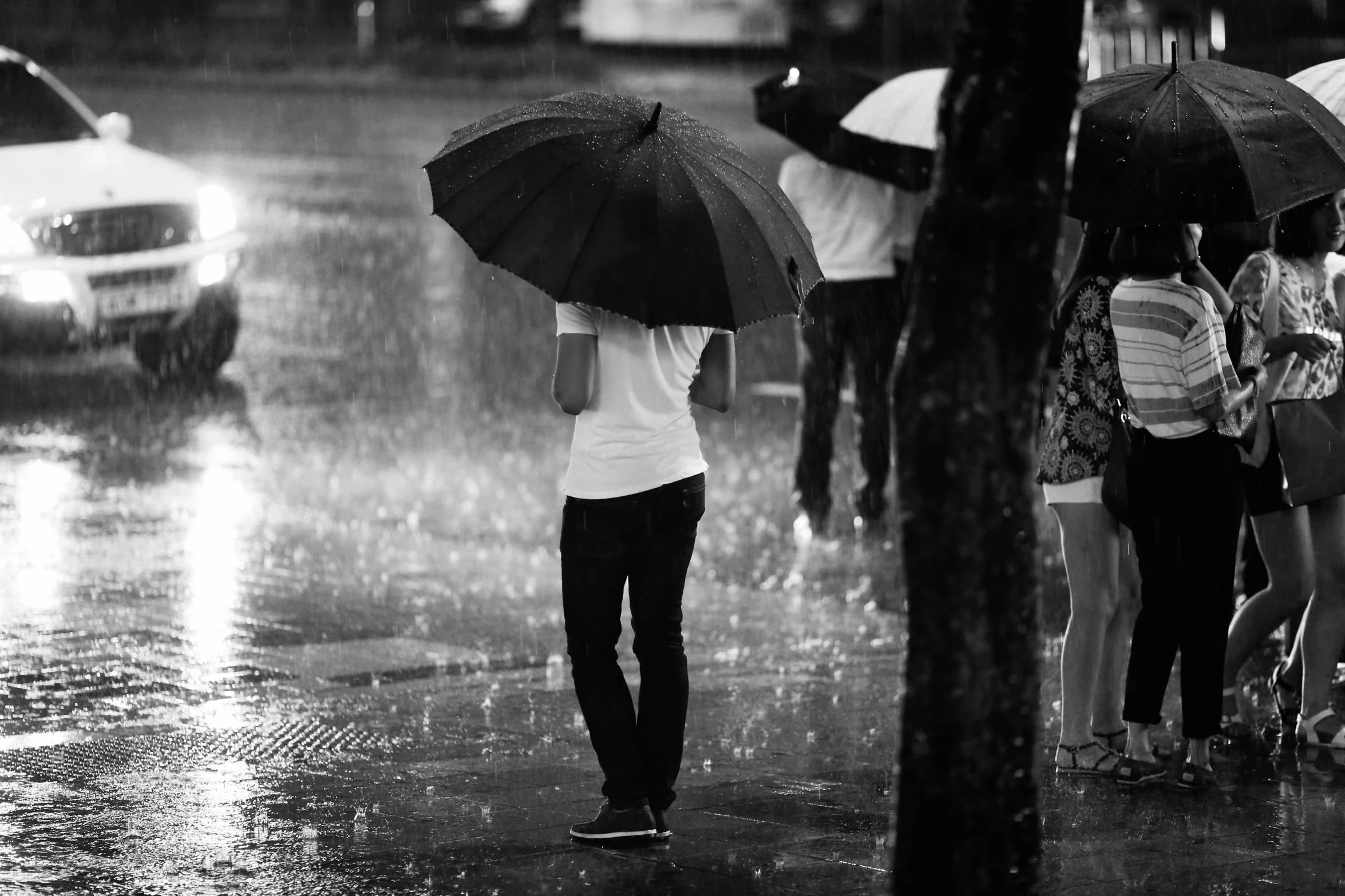 a woman with an umbrella standing in the rain