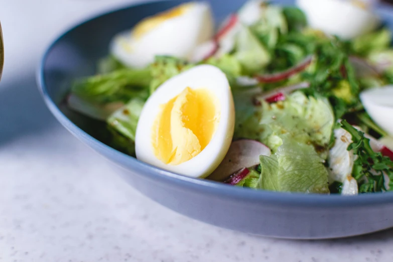 a plate full of salad sitting on a table