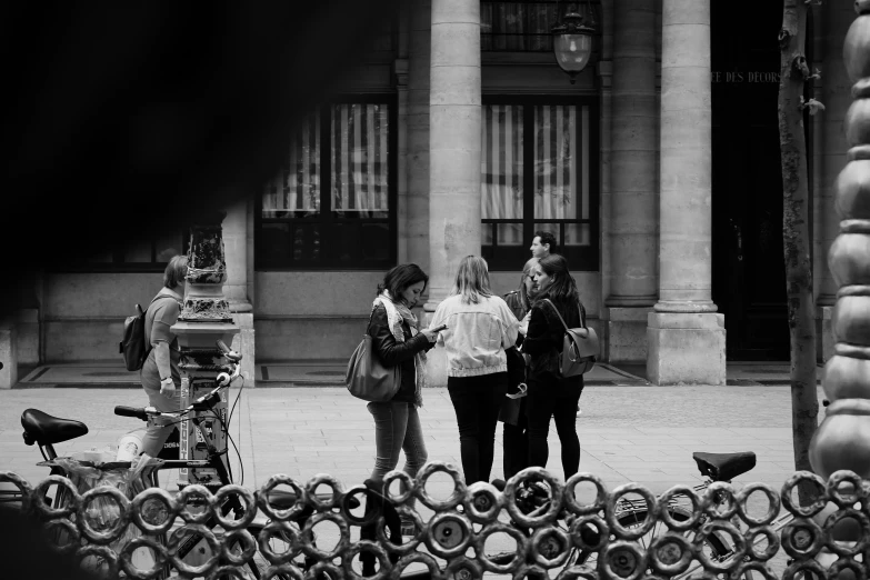 a couple of people standing on the street