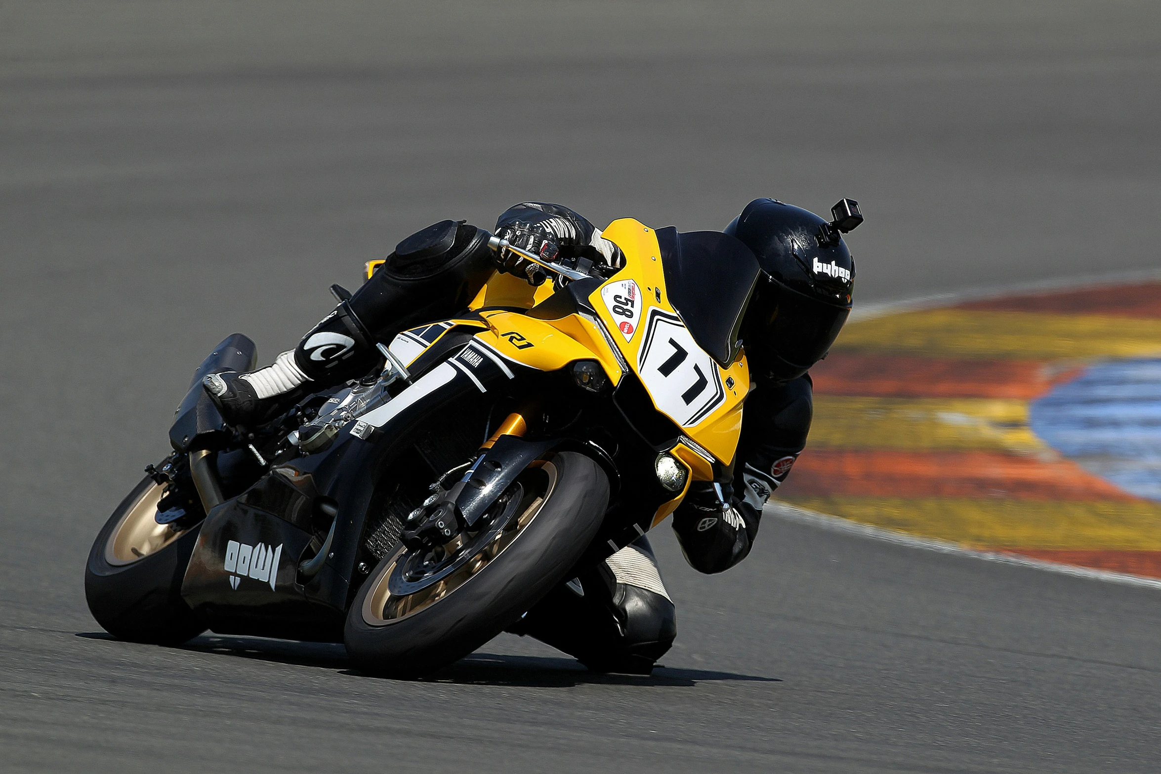 the man is riding a racing bike on the track