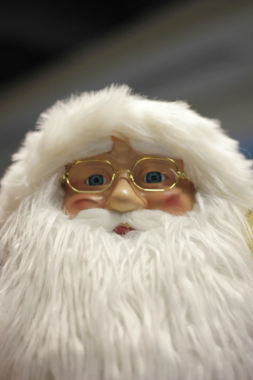 a close up of a santa claus wearing glasses