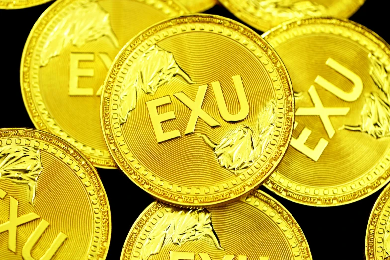 gold exux coins are stacked close to each other