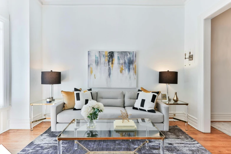 a clean, white and modern living room with a large painting