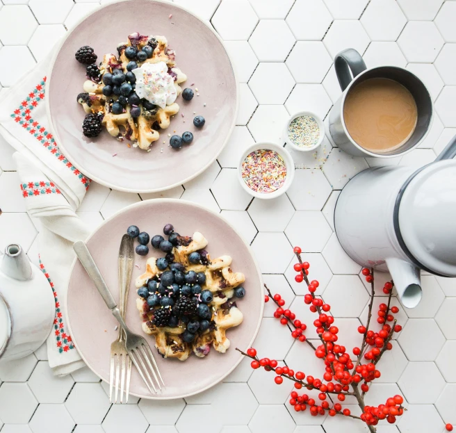 a breakfast plate has two waffles, blueberries and bananas