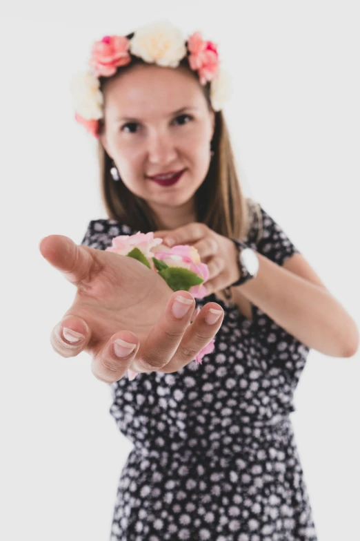 a woman in florals throwing a flower into the air