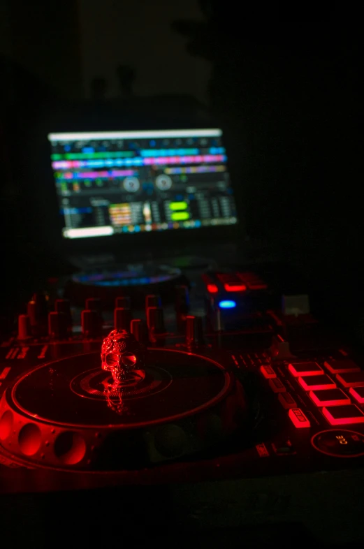 a laptop computer is shown sitting on a dj mixer