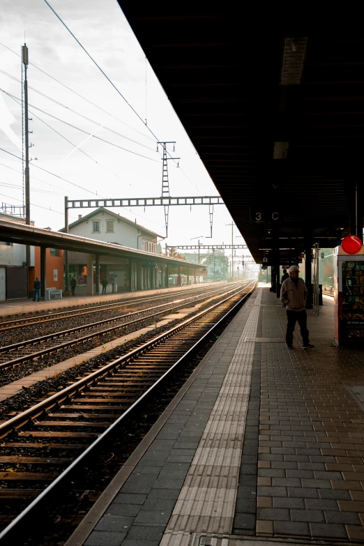 a person walking in front of an empty train station