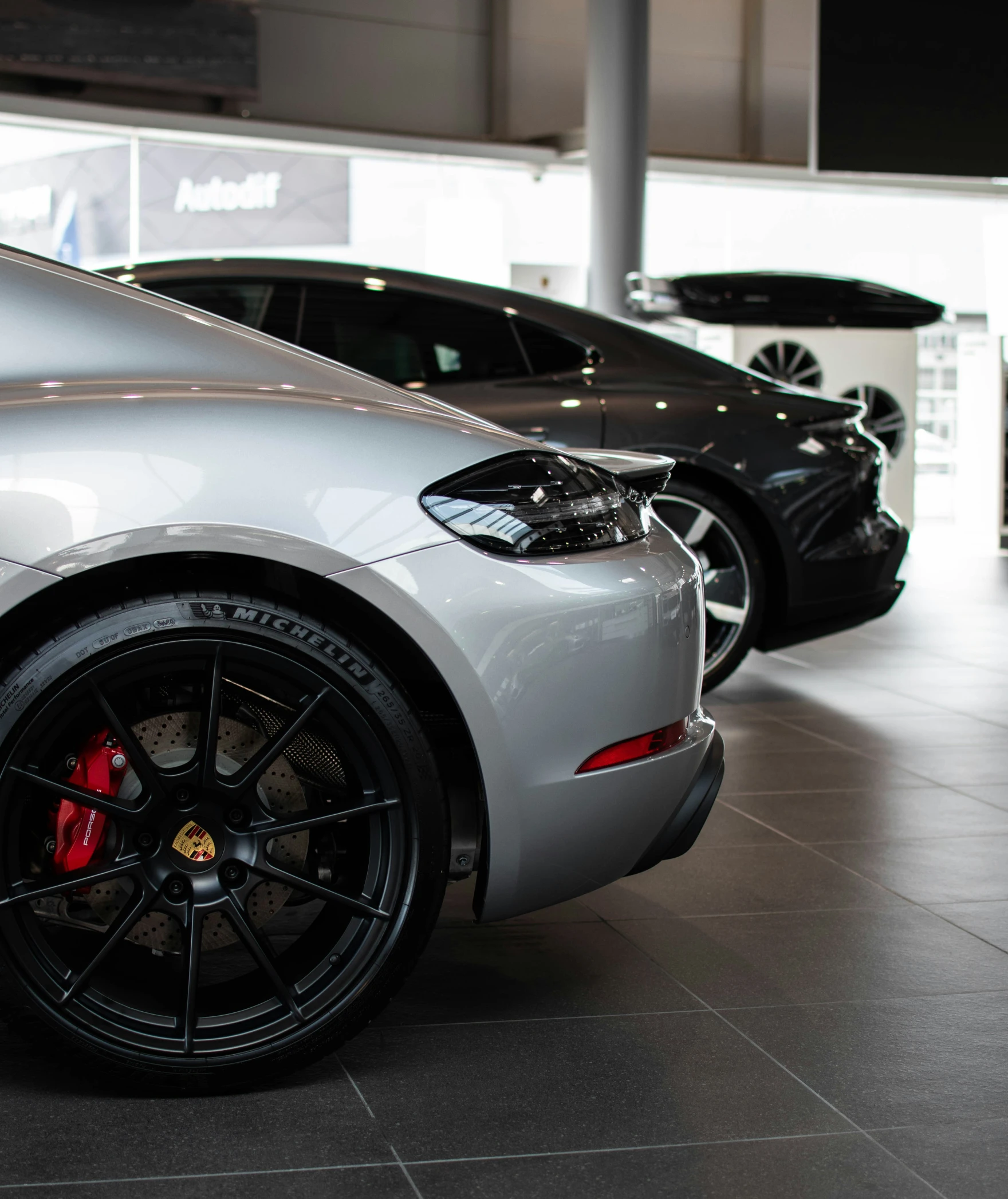 two porsche cars parked next to each other