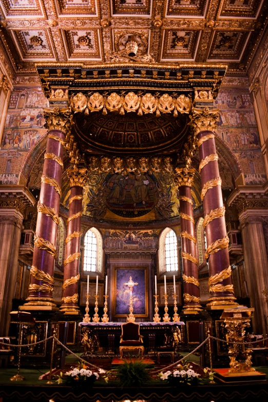 a church has a gold painted ceiling and two windows