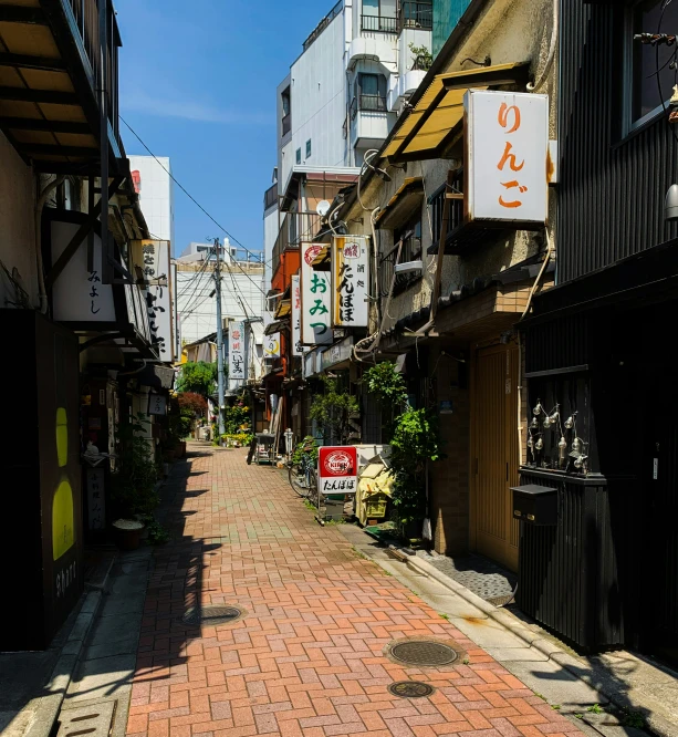 narrow brick street with chinese writing on sign