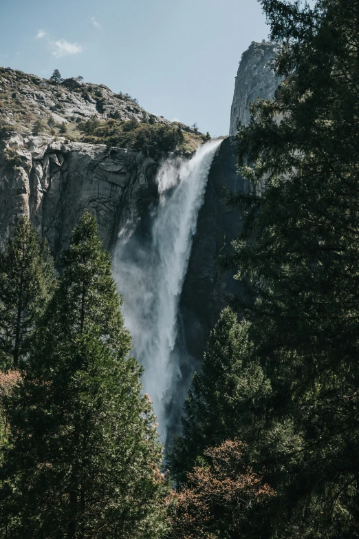 a tall waterfall falling over the side of a cliff