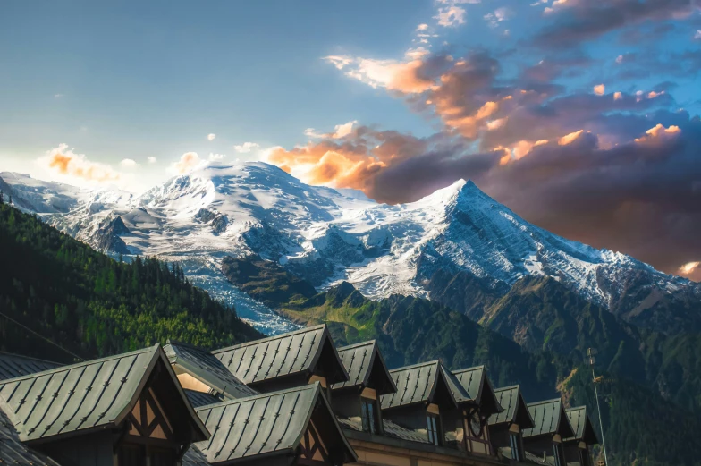 some houses with a snowy mountain in the background