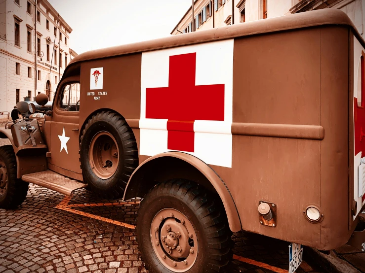 the side view of an army truck with red cross painted on it