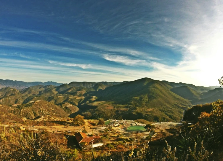 the view of mountains is looking down from the peak