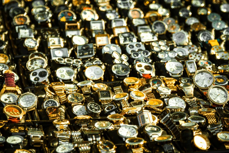 several rows of watches on display in an auction store