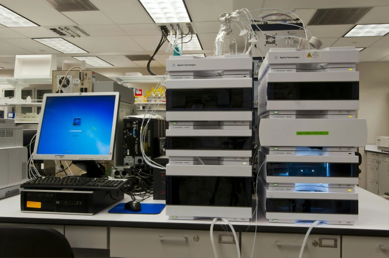 a lab table topped with lots of computer equipment