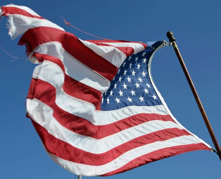 an american flag waving with its wind blowing