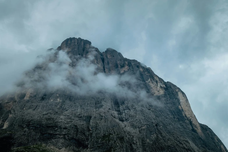 clouds float over the peak of a mountain