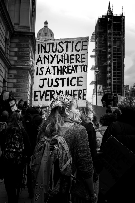 some people on a street with a sign and buildings