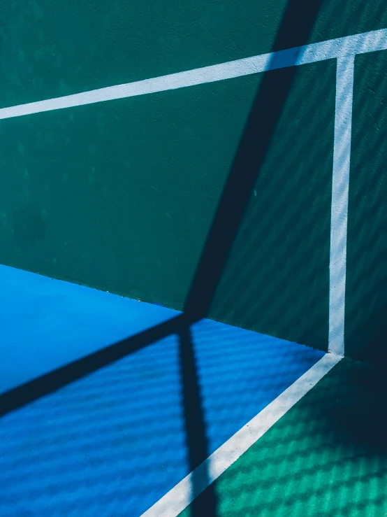 the shadow of a tennis court with the net