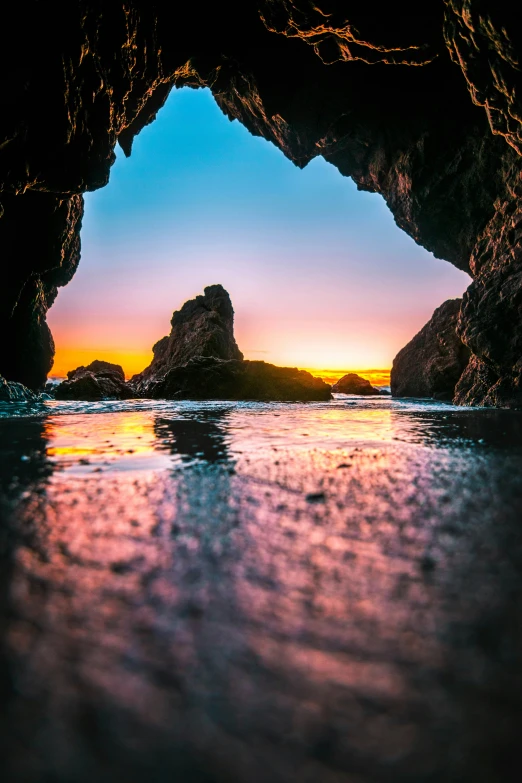 a sea cave with its door open revealing water and rocks