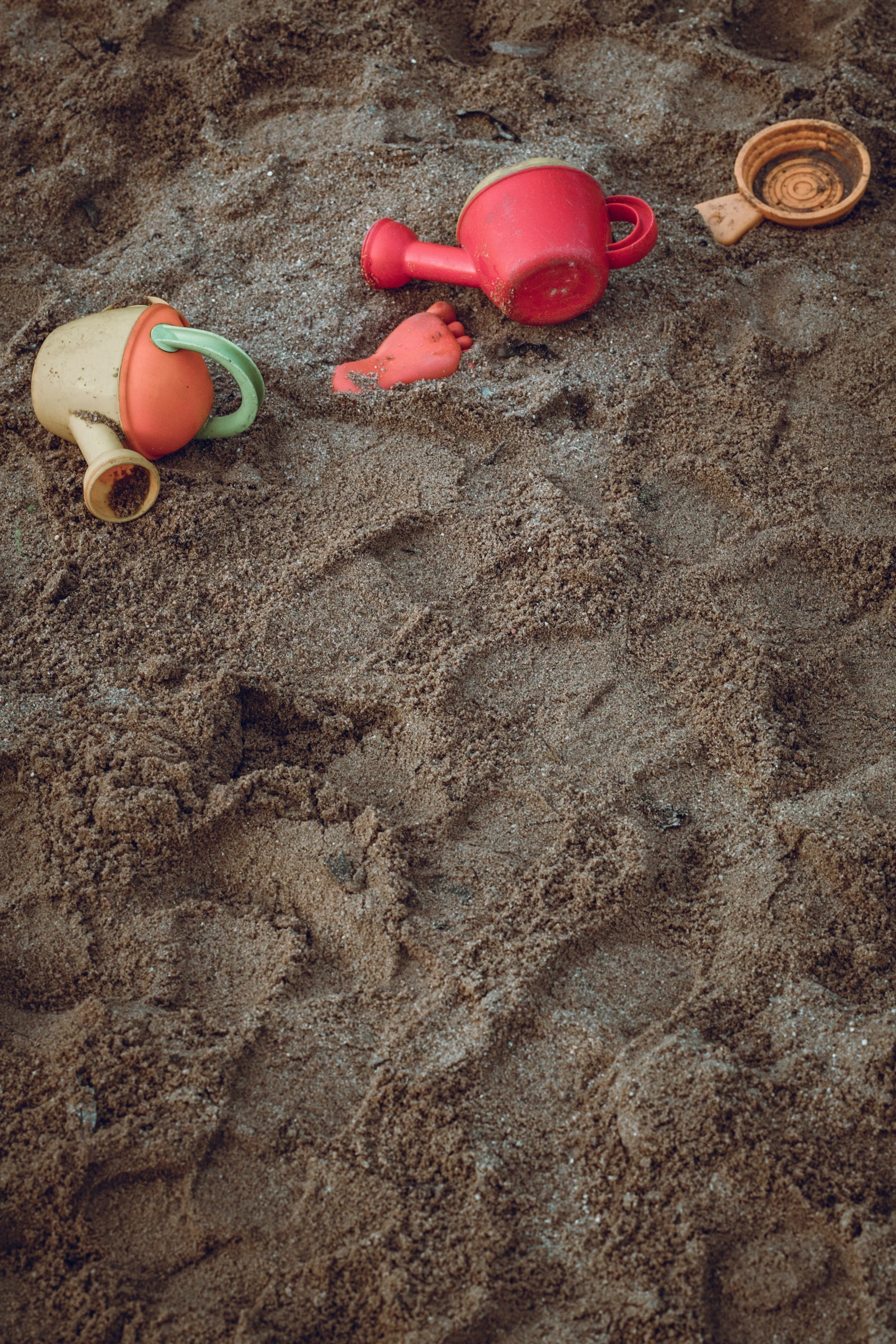 a toy on the ground is laying in the sand