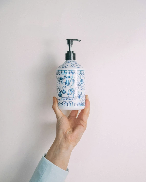 someone holding out their hand to soap onto the sink