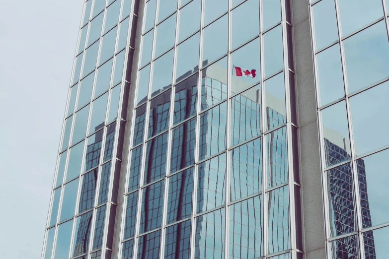 a large building is reflected in the windows