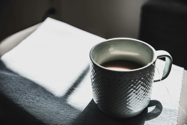 coffee cup sitting on top of a table