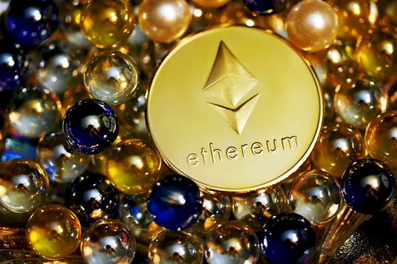 the etherium logo is surrounded by gold and blue marbles