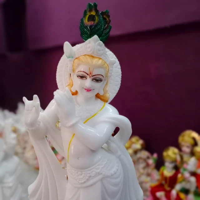 a very pretty statue standing by some white flowers