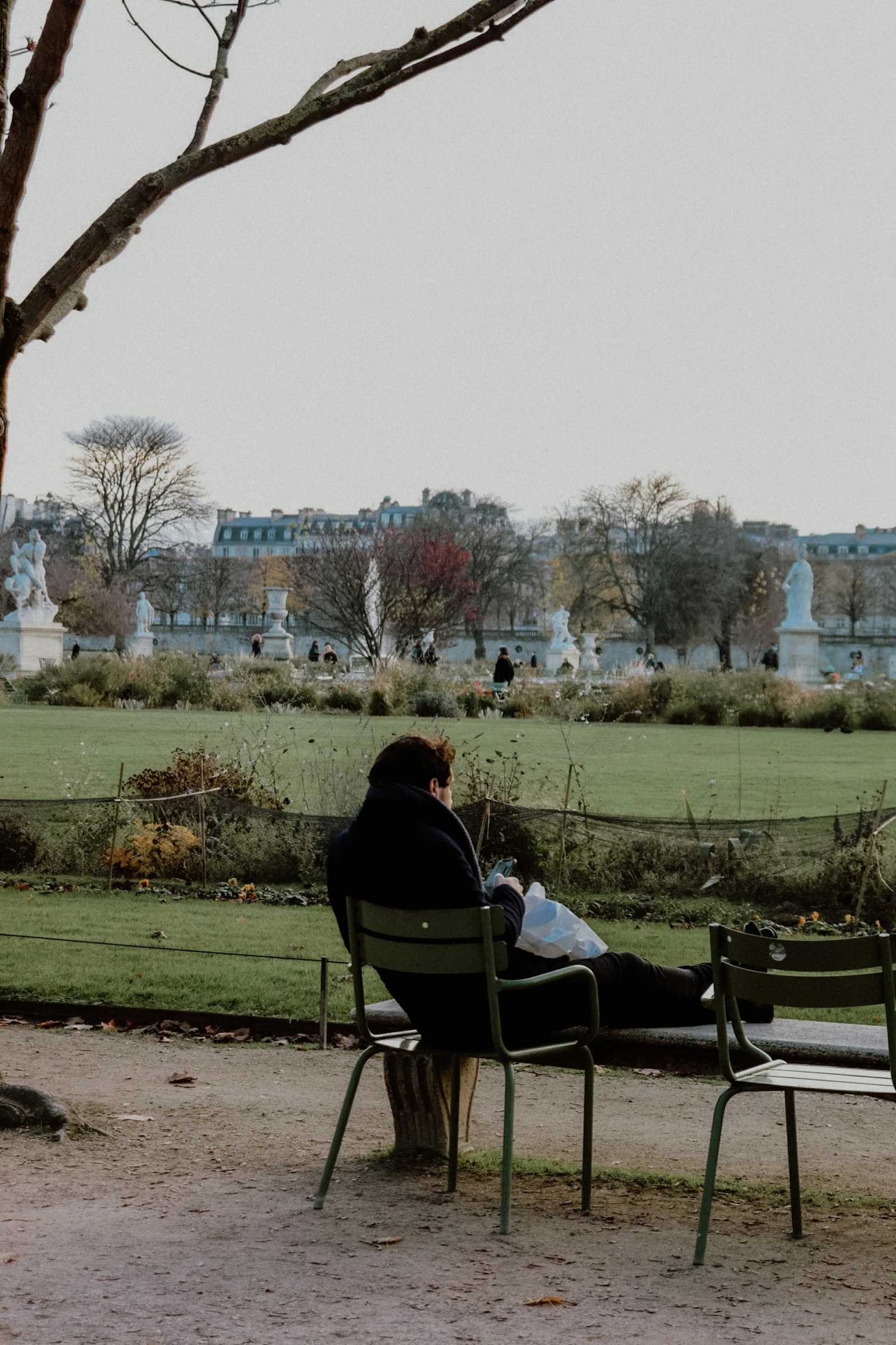 a person sits on a park bench as they enjoy their lunch