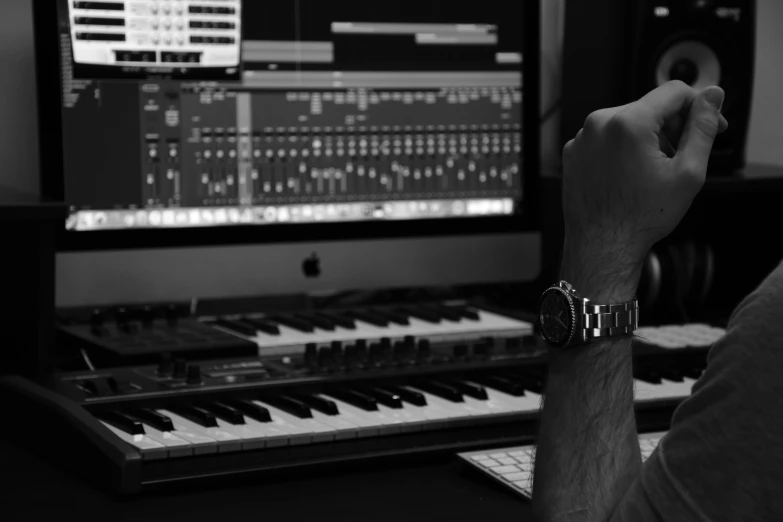 a man in front of a musical organ is watching music play on the screen