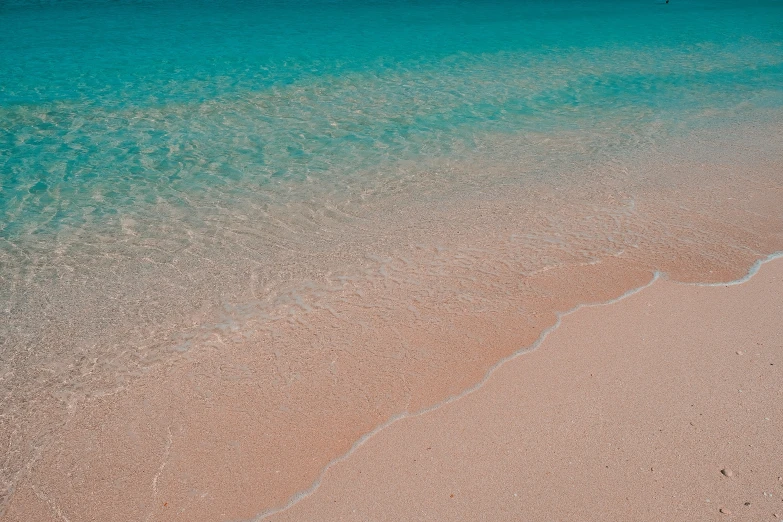 the colors of the water reflects on the sand