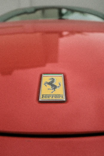 an emblem on the front of a red car