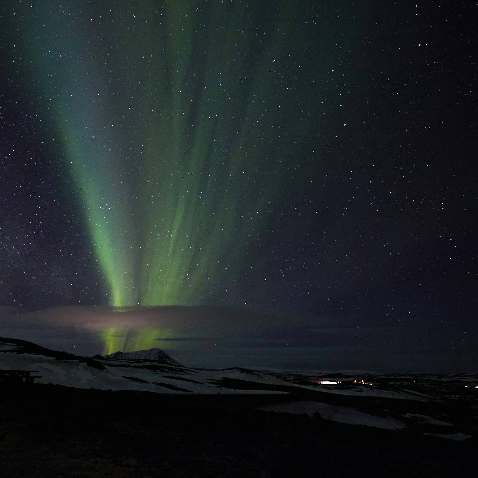 a picture of an aurora above the snow