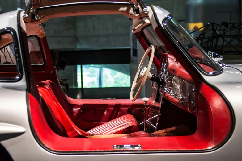 red seat and dashboard in classic car from the 1950's