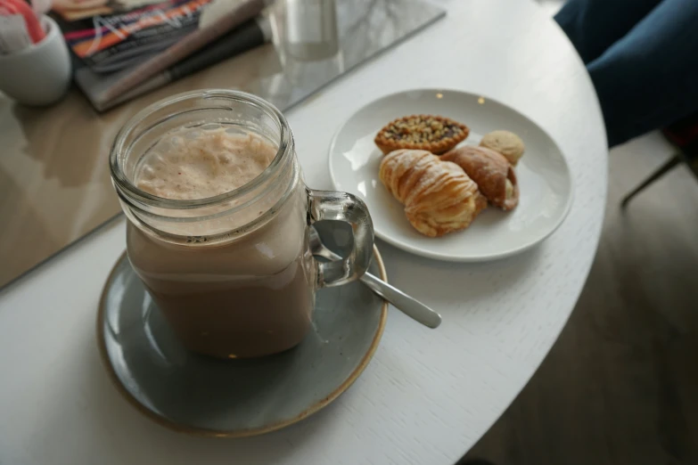 a jar of peanut er and two cookies on a plate